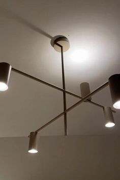 three lights that are on the ceiling in a room