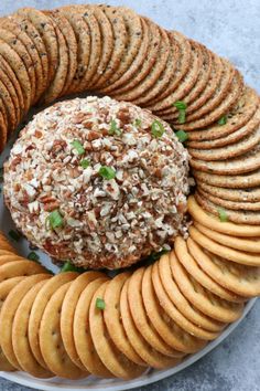 a plate with crackers and a cheese ball on it