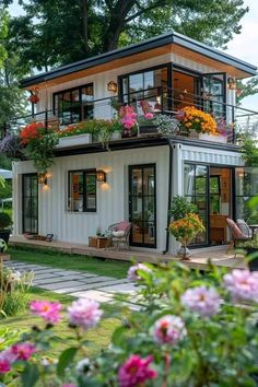 a white house with lots of windows and flowers on the balconies