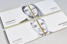 three business cards with the faces of two men