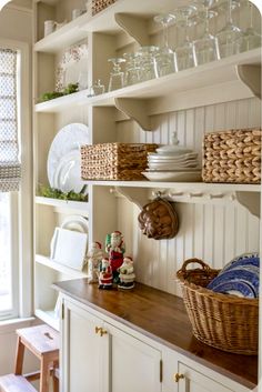 the shelves in this kitchen are filled with dishes and other things to put on them