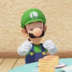 an image of a mario birthday cake on a table with stacks of pancakes in front of it