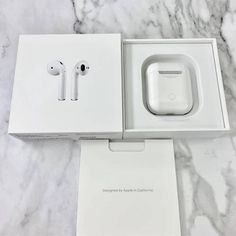 an apple airpods in its box on a marble countertop with the packaging open