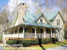 a white house with a blue roof surrounded by trees