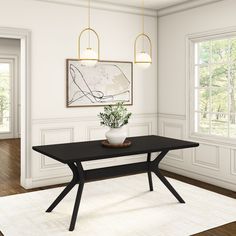 a dining room with a black table and white rug