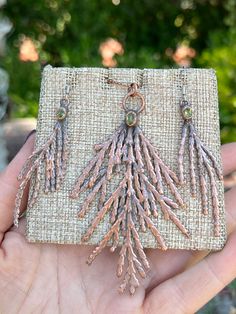 Cedar and Peridot Copper Electroformed Pendant and Earring Set – Octopod Trading Co. Electroformed Jewelry Necklaces, Electroforming Ideas, Electroforming Jewelry, Cedar Leaves, Copper Electroformed Jewelry, Pendant And Earring Set, Electroformed Jewelry, August Birth Stone, Ear Hook