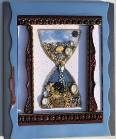 an image of a clock in the shape of a hourglass with gears and beads on it