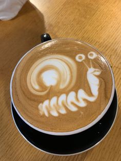 a cappuccino with an animal drawn on it's latte art