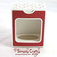 a small red and white box with a hole in the middle that is cut out to look like an oven