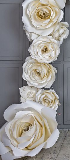 paper flowers are arranged on the wall