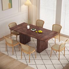 a dining room table with chairs and a bowl of fruit on the table next to it