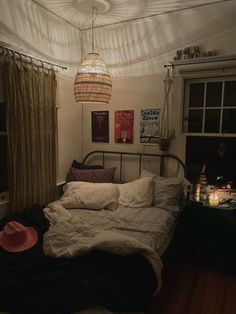 a bed sitting in a bedroom next to a window