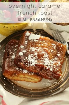 french toast with powdered sugar on top and strawberries in the bowl next to it