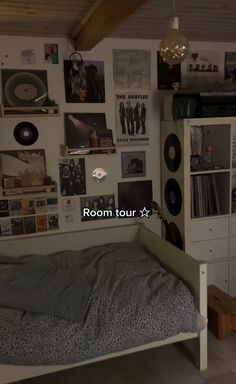 a bedroom with pictures on the wall and a bed in front of a desk area