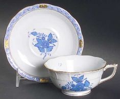 two blue and white dishes with gold trimmings