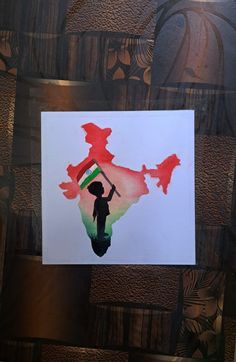 a piece of paper with the shape of india painted in red and green on it