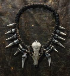 Embrace your inner mystic with the Shaman Necklace, a captivating piece that exudes an aura of ancient wisdom and connection to the spiritual realm. Crafted with intricate details and adorned with bones and fangs, this striking necklace is perfect for LARP events, fantasy gatherings, or as a unique cinema costume accessory. Whether you're attending ConQuest of Mythodea or adding a touch of post-apocalyptic flair to your outfit, this large neck jewelry is a statement piece that will appeal to hor Fantasy Necklaces For Halloween Festival, Adjustable Fantasy Necklaces For Fantasy Events, Adjustable Fantasy Necklace For Fantasy Events, Unique Handmade Necklaces For Cosplay, Unique Handmade Necklace For Cosplay, Handmade Gothic Horned Jewelry, Adjustable Fantasy Necklaces For Cosplay, Adjustable Fantasy Necklace For Cosplay, Adjustable Handmade Necklace For Cosplay