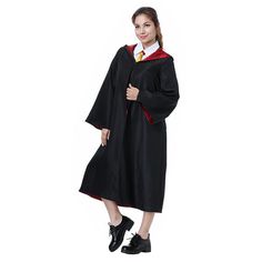 a woman in a graduation gown posing for the camera with her hands on her hips