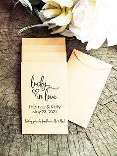 wedding stationery with envelope and flowers on wooden table for guests to sign in love