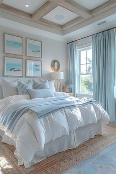 a large white bed sitting in a bedroom next to two windows