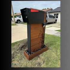 a mailbox sitting in the grass next to a house