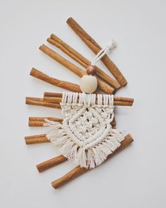 an ornament made out of cinnamon sticks and other items on a white surface