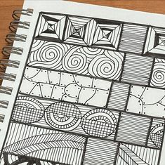 a drawing is shown on top of a spiral notebook with an image of abstract designs