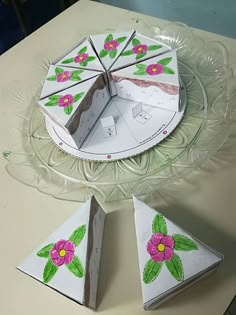 two pieces of cake sitting on top of a glass plate next to another piece of cake