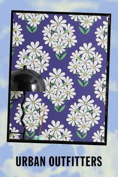 an advertisement for urban outfitters featuring a lamp and flowers on a blue background with white daisies