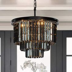 a chandelier hanging from the ceiling in a dining room with white flowers on it