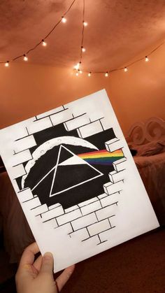 someone holding up a piece of paper with the dark side of the moon on it