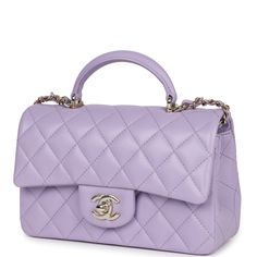 This mini Chanel rectangular flap bag with top handle is in lilac lambskin with light gold tone hardware has a front flap with signature CC turnlock closure, rear half moon pocket, top handle and single interwoven lilac leather and light gold tone chain link shoulder/crossbody strap.The interior is lined in lilac leather and features a zipper pocket with Chanel pull and an open pocket below.Collection: 24POrigin: FranceCondition: New and never worn (plastic on hardware)Accompanied by: Chanel box, Chanel dustbag, carebook, RFID, retail UPC, ribbon and feltMeasurements: 8.5" width x 6" height x 3" depth; 1.77" top handle, 22.5" strap drop Lilac Chanel Bag, Mini Chanel, Chanel Mini Rectangular, Chanel Box, Purple Bag, Chanel Mini, Top Handbags, Bottega Veneta Shoulder Bag, Iconic Bags