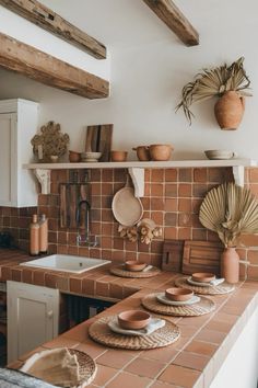 a kitchen counter with plates and bowls on it