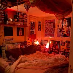 a bed room with a neatly made bed and lots of pictures on the wall above it