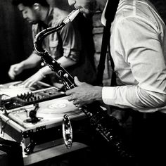 two men are playing music together in black and white