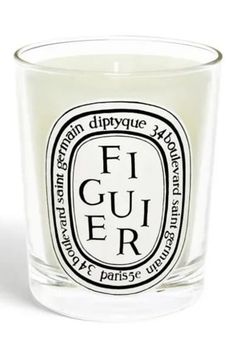 a candle that is sitting in front of a white background with the words freesia on it