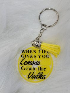 a yellow keychain with the words when life gives you lemons grab the soda