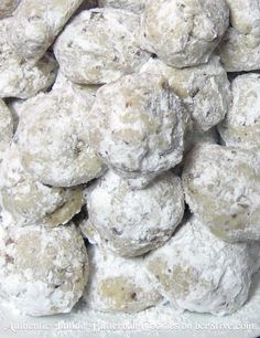 a pile of snowball cookies sitting on top of a table