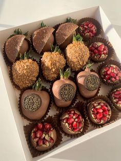 a box filled with lots of different types of chocolates and strawberries on top of each other