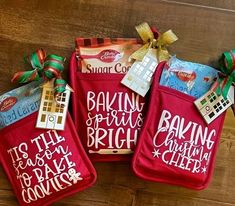 three red oven mitts with the words baking for bright written on them, tied together