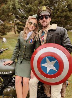 a man and woman dressed up as captain america posing for a photo on a motorcycle