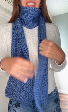 a woman wearing a blue knitted scarf