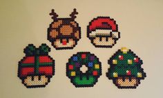 four pixelated christmas ornaments on a white surface