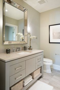 a bathroom with a sink, mirror and toilet in it's centerpieces