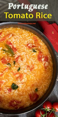 a pan filled with food sitting on top of a table next to tomatoes and peppers