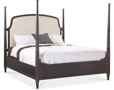 a bed with four posts and pillows on it's headboard, sitting in front of a white background