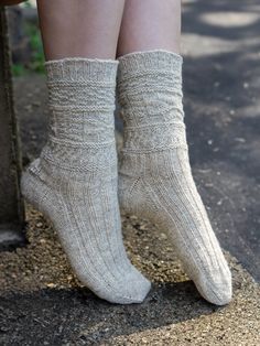 a woman's legs wearing socks and sitting on a bench