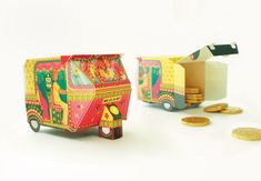 an origami toy truck with coins next to it