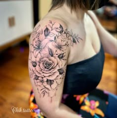 a woman with a flower tattoo on her arm