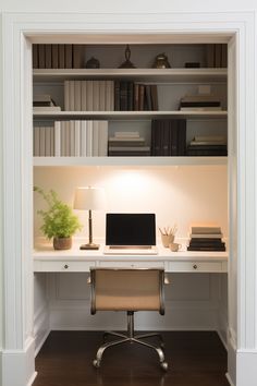 a desk with a computer on top of it in front of bookshelves and shelves